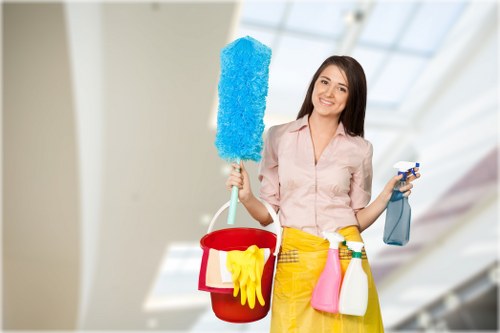 Carpet cleaning technician preparing equipment with safety procedures in Kensal Green